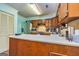 This kitchen features wooden cabinetry, stainless appliances, and an eat-in bar at 335 Jeff Davis Pl, Fayetteville, GA 30214