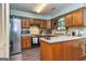 This kitchen features wooden cabinetry, stainless appliances, and an eat-in bar at 335 Jeff Davis Pl, Fayetteville, GA 30214