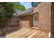 Cozy wooden deck adjoins a brick house and features a unique, privacy-enhancing wooden fence at 4014 Golfview Dr, Villa Rica, GA 30180