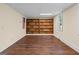 Versatile basement featuring custom built-in wooden shelving, a window, and vinyl floors at 4014 Golfview Dr, Villa Rica, GA 30180