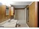 Traditional bathroom with a neutral color scheme, wooden paneling, and tub with a shower at 4014 Golfview Dr, Villa Rica, GA 30180