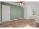 Unique bedroom with modern accent wall and wood laminate flooring at 4014 Golfview Dr, Villa Rica, GA 30180
