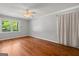 Cozy bedroom with hardwood floors, a ceiling fan, and natural light at 4014 Golfview Dr, Villa Rica, GA 30180