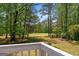 Golf course views from this deck are peaceful and framed by mature trees on a sunny day at 4014 Golfview Dr, Villa Rica, GA 30180