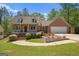 Charming brick home with a well-manicured lawn, mature trees, and a welcoming front porch at 4014 Golfview Dr, Villa Rica, GA 30180