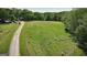 Aerial view of a country home, complete with open grazing land and livestock at 201 Little New York Rd, Carrollton, GA 30116