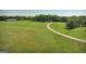 A sprawling green pasture encompasses this property and leads to a farmhouse and barn at 201 Little New York Rd, Carrollton, GA 30116