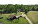 Aerial view of horse barn and pens near wooded home on expansive land, offering privacy at 201 Little New York Rd, Carrollton, GA 30116