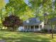 Inviting home with a covered front porch, mature trees, and a neatly maintained lawn at 201 Little New York Rd, Carrollton, GA 30116