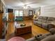 Open-concept living room boasts hardwood floors, ceiling fan, plenty of light and comfortable furniture at 201 Little New York Rd, Carrollton, GA 30116