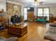 Spacious living area featuring hardwood floors, a ceiling fan, fireplace and comfortable seating at 201 Little New York Rd, Carrollton, GA 30116