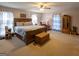 Bright primary bedroom featuring carpet floors, ceiling fan, large windows and ample closet space at 201 Little New York Rd, Carrollton, GA 30116