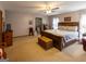 Spacious primary bedroom showcasing a large bed, carpeted floors, a ceiling fan, and a bathroom at 201 Little New York Rd, Carrollton, GA 30116