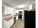Modern kitchen featuring granite countertops, white cabinets, and stainless steel appliances at 2361 Collier Dr, Decatur, GA 30032