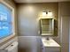 Bathroom features a window, neutral wall color, and a mirror above a vanity at 2818 Lynda Pl, Decatur, GA 30032