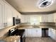 Updated kitchen boasts granite countertops, stainless appliances, and white cabinetry at 2818 Lynda Pl, Decatur, GA 30032