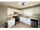 Modern kitchen with white cabinets, granite countertops, and stainless steel appliances at 2818 Lynda Pl, Decatur, GA 30032