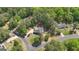 Aerial view of the home in a wooded neighborhood with plenty of lush trees and a well manicured lawn at 65 Jacksons Vly, Sharpsburg, GA 30277