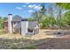 Expansive backyard with a screened porch, fire pit and mature trees offers an ideal outdoor living space at 65 Jacksons Vly, Sharpsburg, GA 30277