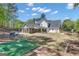 Large backyard with a basketball court, fire pit area, and covered patio, ideal for outdoor living at 65 Jacksons Vly, Sharpsburg, GA 30277
