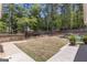 Large, well-maintained backyard featuring a grassy lawn, privacy fence, and patio area at 65 Jacksons Vly, Sharpsburg, GA 30277