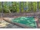 Backyard basketball court, enclosed with a fence, offers a private and fun recreational space at 65 Jacksons Vly, Sharpsburg, GA 30277