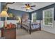 Blue bedroom features a bed, ceiling fan, two windows and an interesting display piece on the wall at 65 Jacksons Vly, Sharpsburg, GA 30277