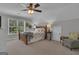 Bedroom with a ceiling fan, carpet, and a window letting in natural light at 65 Jacksons Vly, Sharpsburg, GA 30277