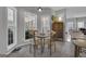 Cozy breakfast nook with a wooden table, chairs, bright windows, and tiled floor with access to the living room at 65 Jacksons Vly, Sharpsburg, GA 30277