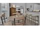 Breakfast area with wood table, chairs and bar seating area opening to the living room at 65 Jacksons Vly, Sharpsburg, GA 30277