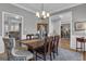 Dining room with a rustic wooden table and views into adjacent living spaces at 65 Jacksons Vly, Sharpsburg, GA 30277