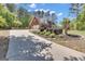 Long driveway leading to a beautiful red brick home with lush landscaping and mature trees at 65 Jacksons Vly, Sharpsburg, GA 30277