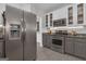 Kitchen with stainless steel refrigerator and appliances, light gray lower and white upper cabinets at 65 Jacksons Vly, Sharpsburg, GA 30277