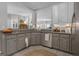 Gray kitchen with granite countertops, stainless steel appliances, and an open layout, perfect for modern living at 65 Jacksons Vly, Sharpsburg, GA 30277