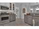 Well-lit kitchen featuring stainless steel appliances, granite counters, and white cabinets with glass fronts at 65 Jacksons Vly, Sharpsburg, GA 30277