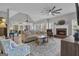 Bright living room featuring a brick fireplace, vaulted ceiling, ceiling fan and hardwood flooring at 65 Jacksons Vly, Sharpsburg, GA 30277