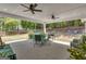Spacious outdoor patio with covered seating, a dining table, and a view of the fenced backyard at 65 Jacksons Vly, Sharpsburg, GA 30277