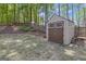 Durable outdoor shed with double doors and windows offers plenty of storage and matches the property's appeal at 65 Jacksons Vly, Sharpsburg, GA 30277