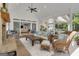 Bright sunroom with exposed brick, wicker furniture, and a view into the home at 65 Jacksons Vly, Sharpsburg, GA 30277