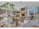 Bright sunroom with high ceilings, exposed brick, wicker furniture, and a view of the backyard at 65 Jacksons Vly, Sharpsburg, GA 30277