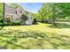 Sprawling backyard with verdant lawn and mature trees offering tons of room for outdoor games and activities at 110 Cadmium Ct, Peachtree City, GA 30269