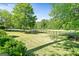 Lush, fenced backyard offering privacy, featuring a pristine lawn and mature trees at 110 Cadmium Ct, Peachtree City, GA 30269