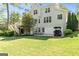 Large backyard showcasing a spacious lawn, patio, and mature trees with an inground sprinkler system at 110 Cadmium Ct, Peachtree City, GA 30269