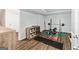 Finished basement with work out area including weight rack and organization unit with baskets on dark laminate flooring at 110 Cadmium Ct, Peachtree City, GA 30269