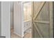 Bathroom features a barn door entry, a vanity with drawers, and light colored tiles at 110 Cadmium Ct, Peachtree City, GA 30269