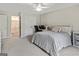 Spacious bedroom with plush carpet, a ceiling fan, and an adjoining bathroom at 110 Cadmium Ct, Peachtree City, GA 30269