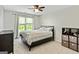 A bedroom is decorated with a queen bed, curtains, and a dark brown storage unit at 110 Cadmium Ct, Peachtree City, GA 30269