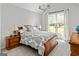Bedroom featuring vaulted ceilings, a chandelier, and a large window offering natural light at 110 Cadmium Ct, Peachtree City, GA 30269