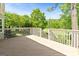 Spacious outdoor deck with white railings, offering views of the surrounding greenery at 110 Cadmium Ct, Peachtree City, GA 30269