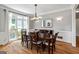 Bright dining room featuring hardwood floors, a modern chandelier, and large windows at 110 Cadmium Ct, Peachtree City, GA 30269